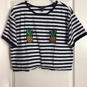 Striped crop top with pineapple patches.